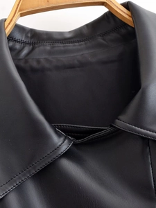 Detail view of the black PU leather jacket lapel and premium stitching texture