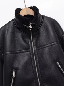 Detail of black faux leather aviator jacket with thick shearling collar and metal buckle