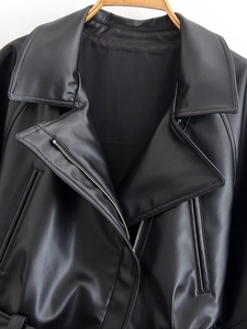 Detailed close-up of premium black PU leather jacket showing silver metal zipper and lapel
