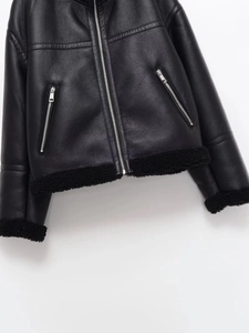 Detailed view of black faux leather aviator jacket with cozy fleece lining and silver zip