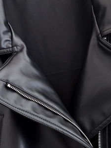 Close-up of high-quality black PU leather jacket texture with silver metal zipper detail