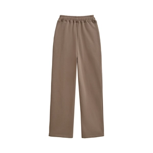 Detail of taupe wide-leg pants featuring a comfortable elastic waistband and fluid drape