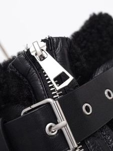Detail of silver metal zipper and black leather strap with soft plush fleece lining