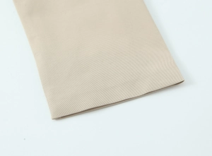 Detail of high-quality twill fabric texture and neat stitching on beige trench coat cuff