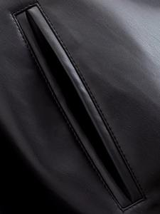 Macro detail of the premium matte black PU leather jacket with precise welt pocket stitching