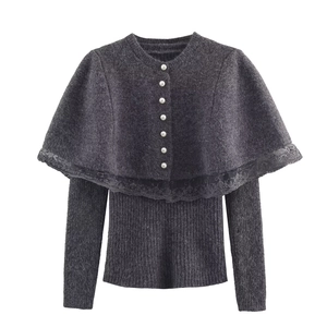 Detail of grey knitted sweater with lace-edged capelet and elegant pearl buttons