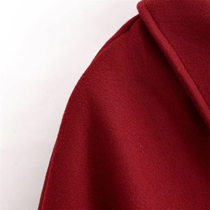Detail of burgundy wool coat showing a classic collar and textured heavy fabric
