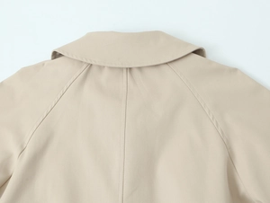 Detail view of khaki trench coat back collar and raglan sleeve stitching quality