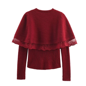 Detail of red knit sweater with lace shawl overlay and vertical ribbed texture design