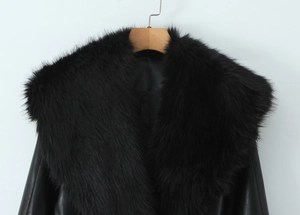 Close-up of luxury faux fur collar on black glossy PU leather jacket for women