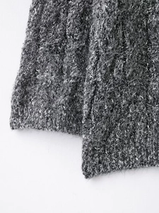 Detail of grey marl knitted sweater showing the fine texture and blended fabric fibers