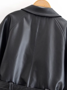 Detail of black leather PU jacket back with smooth texture and raglan sleeve stitching