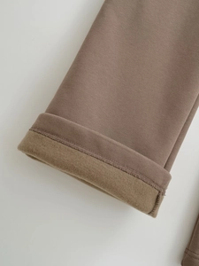 Detailed macro view of thermal fleece lining inside brown leisure drawstring pants