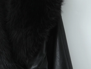 Close-up detail of luxurious faux fur collar and black PU leather jacket material
