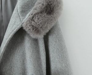 Detailed macro view of gray wool coat fabric texture and fluffy faux fur collar detail