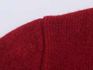 Close-up of red wool-blend knitwear showing soft brushed texture and vertical ribbed pattern