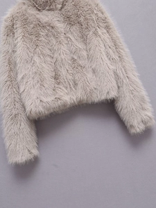 Close-up of the dense and fluffy faux fur texture on this gray-brown cropped jacket