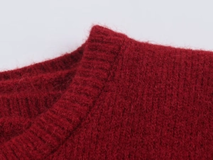 Close-up of wine red mohair knitwear showing fluffy fiber texture and ribbed hem detail