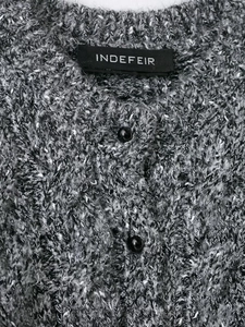 Detail view of heather grey knit cardigan texture and black button closure with label