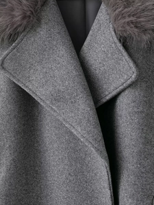 Macro detail of high-quality dark grey wool coat with plush faux fur collar and stitching
