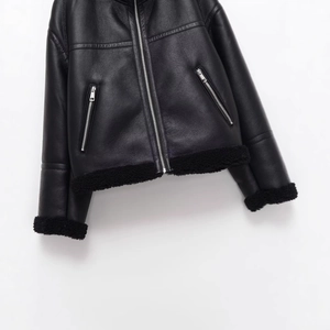 Minimalist black faux leather fleece jacket with silver zippers and shearling trim