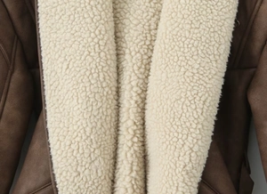 Dettaglio giacca in finta pelle scamosciata con spessa fodera in shearling bianco