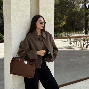 Women's dark brown oversized zip-up wool jacket styled with a matching suede handbag