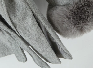 Close-up of grey wool texture with faux fur trim and premium satin lining details