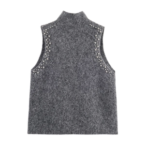 Detailansicht der grauen Strickweste mit flauschiger Textur und Perlenbesatz an der Schulter