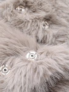 Detailed close-up of metallic snap buttons on soft grey faux fur coat fabric