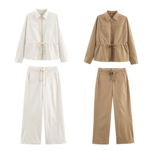 Detail of drawstring waist jacket and wide leg pants set with utility chest pockets