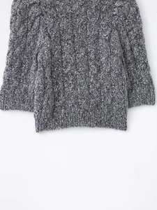 Detail of grey and white mixed knit cardigan with chunky texture and ribbed edges