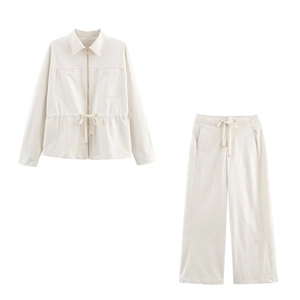 Detail of off-white casual set showing high-density fabric and gold zipper jacket
