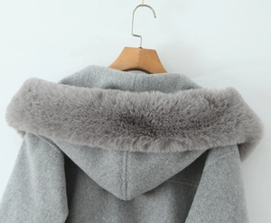Close-up of winter grey hooded coat featuring premium thick faux fur trim on the hood