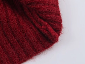 Close-up of wine red ribbed knit fabric with soft mohair texture and wool fibers