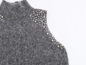 Detail eines dunkelgrauen Strickpullovers mit Strasssteinen und weicher Mohair-Textur