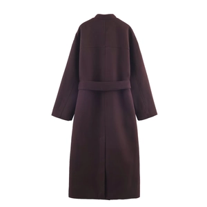 Detail view of the back of a long purple wool coat with stand collar and waist belt detail
