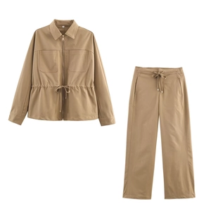 Detail of khaki two-piece leisure set featuring drawstring jacket and straight pants