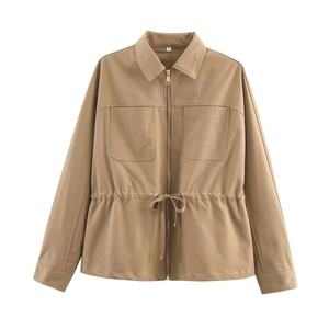 Detail of khaki utility jacket featuring adjustable drawstring waist and chest flap pockets