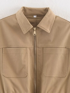 Detail of khaki twill jacket showing lapel collar, metal zipper, and large pockets