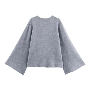 Detail of grey oversized knit cardigan showing thick fabric texture and bell sleeve design