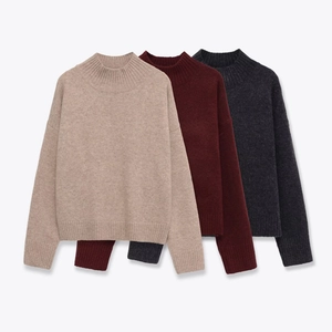 Detail of ribbed cuffs and high-neck design on three colors of knit sweaters