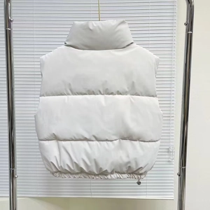 Detail view of cropped PU leather puffer vest with horizontal quilting and drawstring hem