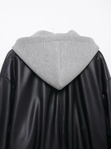 Detail of faux leather jacket featuring contrast grey jersey hood on the back