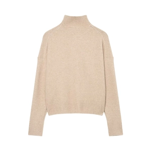 Close-up of oatmeal high-neck knit sweater featuring decorative shoulder ribbing and textures