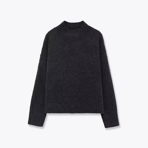 Close-up of charcoal grey mock neck sweater with ribbed cuffs and soft knit texture