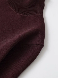 Close-up of ribbed mock neck design and fine stitching on dark wine red sweater