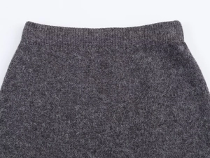 Detailed macro view of high-quality dark grey ribbed knit waistband and soft wool fabric
