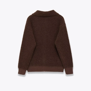 Detailed back view of a thick dark brown sherpa jacket with ribbed cuffs and hem