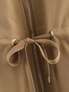 Detail of khaki twill jacket showing metal zipper and adjustable drawstring with eyelets